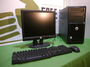 a desktop computer with monitor, keyboard, and mouse on a green table cloth