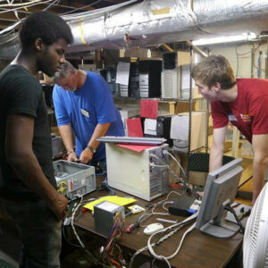 a group of volunteers refurbish computers