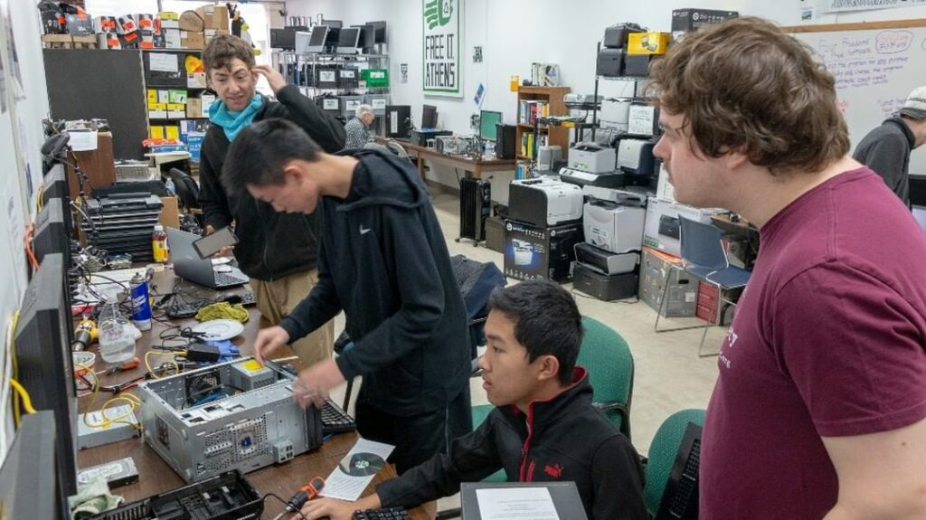 a group of volunteers working on desktops