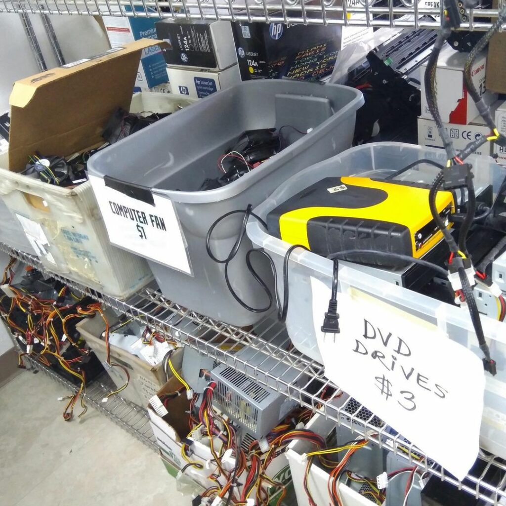store shelves with bins of used computer parts