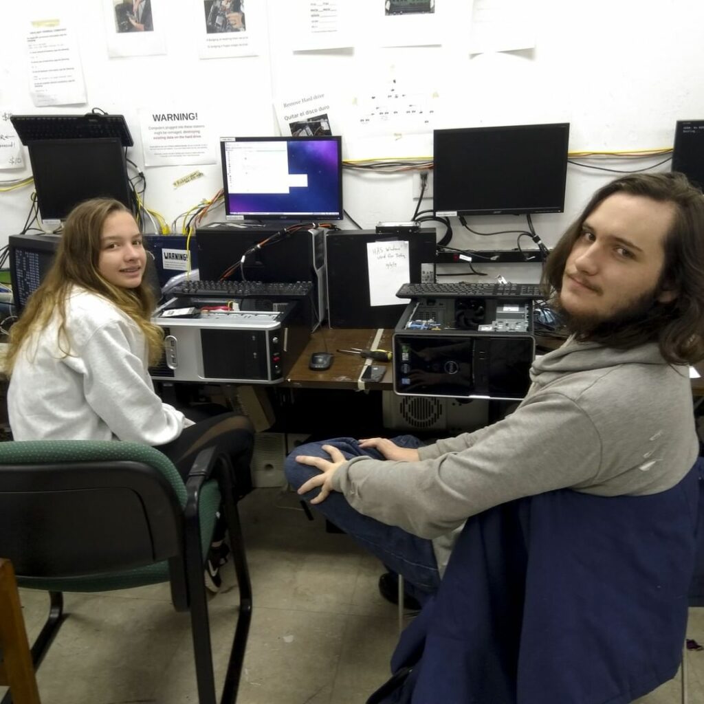 Two volunteers refurbish computers