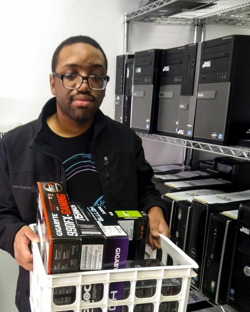 Volunteer with a bin of graphics cards